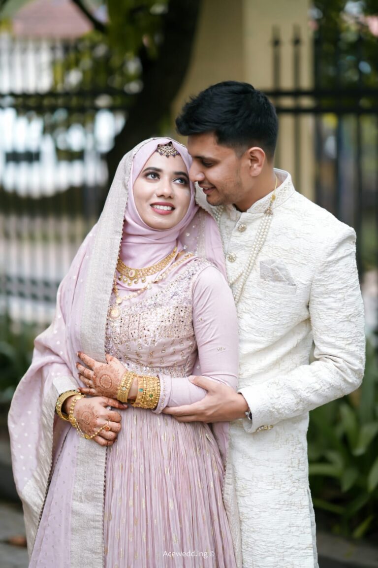 Couple dressed in formal attire, standing closely together outdoors, with their faces blurred.